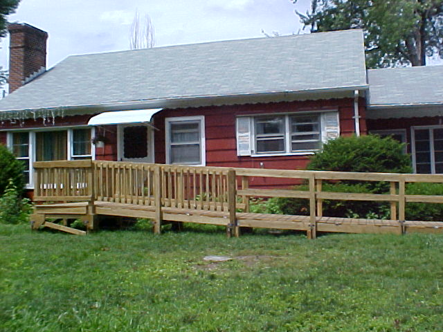 ramp in front of red ranch house