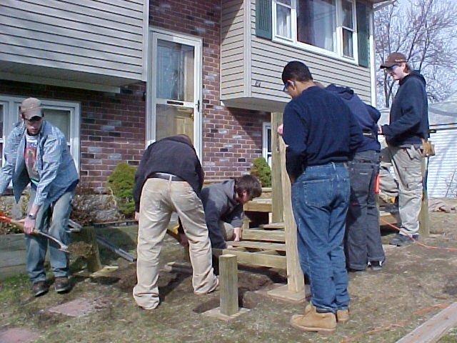 Men working on entrance ramp to home